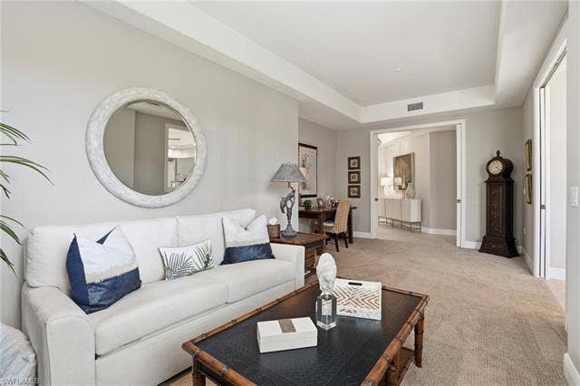 19620 Marino Lake Cir, #2802, Miromar Lakes, FL 33913 Carpeted living room with a tray ceiling and baseboards