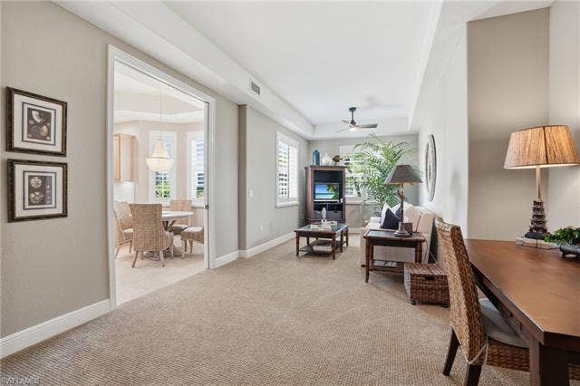 19620 Marino Lake Cir, #2802, Miromar Lakes, FL 33913 Living area featuring light carpet, ceiling fan, and a raised ceiling