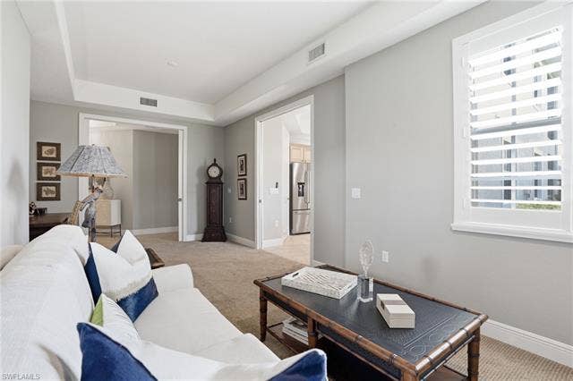 19620 Marino Lake Cir, #2802, Miromar Lakes, FL 33913 Living area with light colored carpet and a tray ceiling