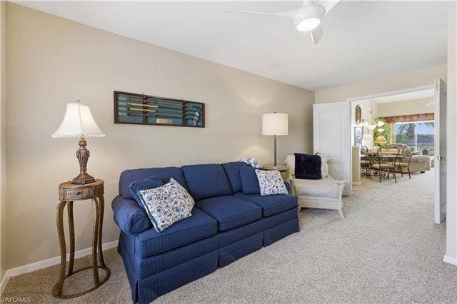 23541 Sandycreek Ter, #806, Estero, FL 34135 Living area with carpet flooring and a ceiling fan