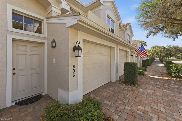 23541 Sandycreek Ter, #806, Estero, FL 34135 Entrance to property featuring stucco siding and driveway