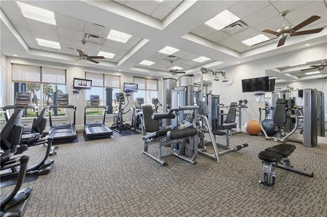 23541 Sandycreek Ter, #806, Estero, FL 34135 Workout area with a ceiling fan, a paneled ceiling, and a raised ceiling