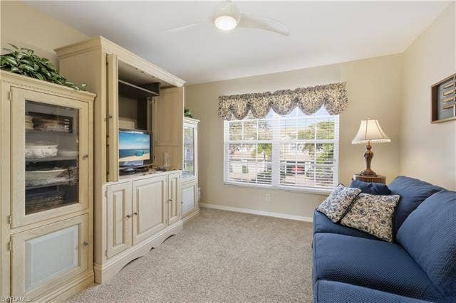 23541 Sandycreek Ter, #806, Estero, FL 34135 Living area with a ceiling fan and light carpet