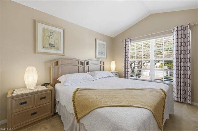 23541 Sandycreek Ter, #806, Estero, FL 34135 Bedroom featuring carpet flooring and vaulted ceiling