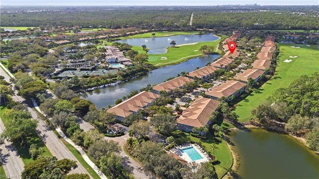 23541 Sandycreek Ter, #806, Estero, FL 34135 Aerial overview of property's location featuring a nearby body of water, a golf course, and nearby suburban area