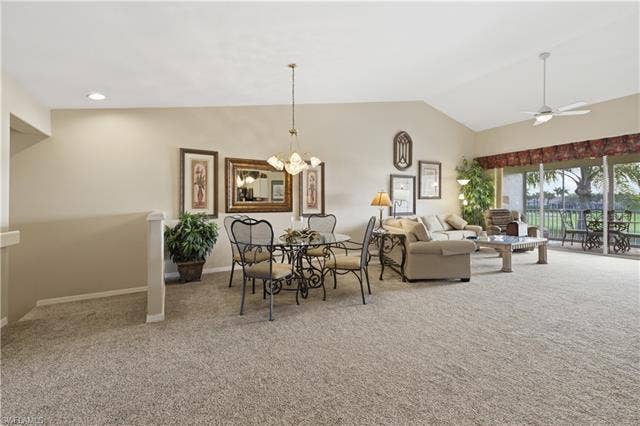 23541 Sandycreek Ter, #806, Estero, FL 34135 Living area with a ceiling fan, light colored carpet, hanging lights, and lofted ceiling