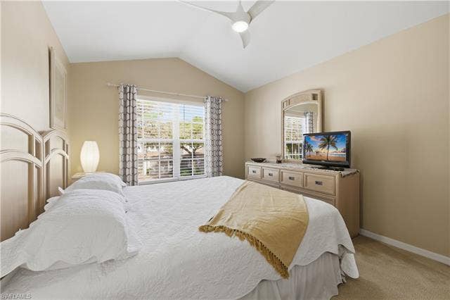 23541 Sandycreek Ter, #806, Estero, FL 34135 Bedroom featuring vaulted ceiling, light colored carpet, and a ceiling fan