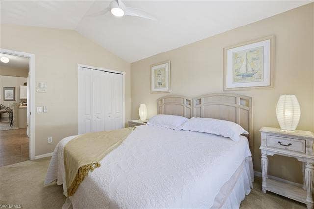 23541 Sandycreek Ter, #806, Estero, FL 34135 Bedroom with lofted ceiling, light carpet, a closet, and a ceiling fan