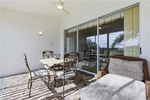 23541 Sandycreek Ter, #806, Estero, FL 34135 Sunroom with ceiling fan, outdoor dining space, and a patio