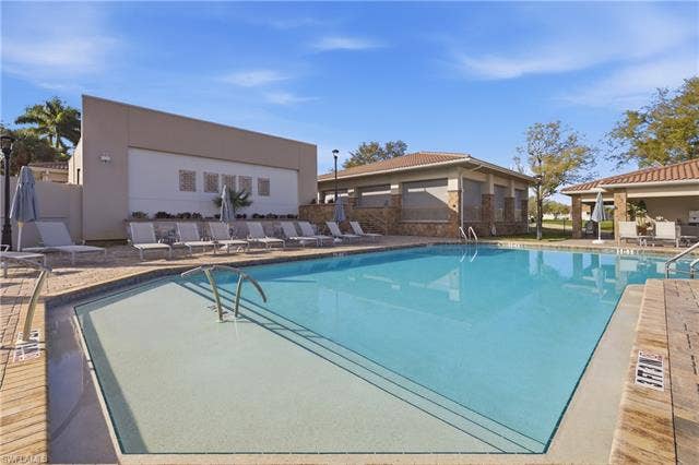 23541 Sandycreek Ter, #806, Estero, FL 34135 Community pool featuring a patio