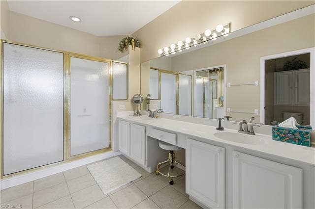 23541 Sandycreek Ter, #806, Estero, FL 34135 Full bath featuring double vanity, a shower stall, and light tile patterned floors