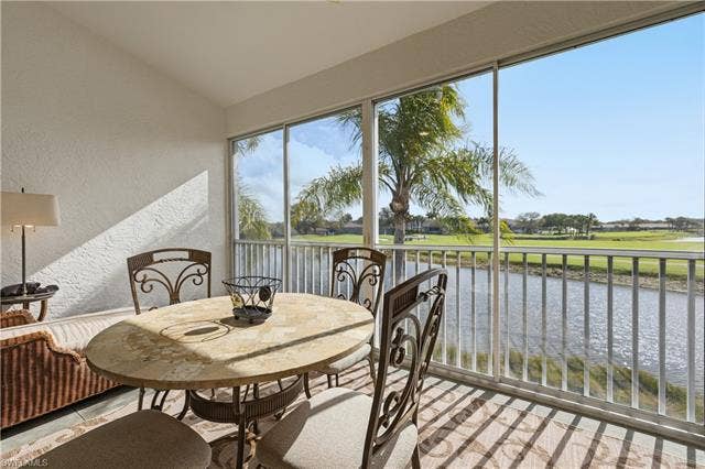 23541 Sandycreek Ter, #806, Estero, FL 34135 Sunroom / solarium with a water view, vaulted ceiling, and view of golf course