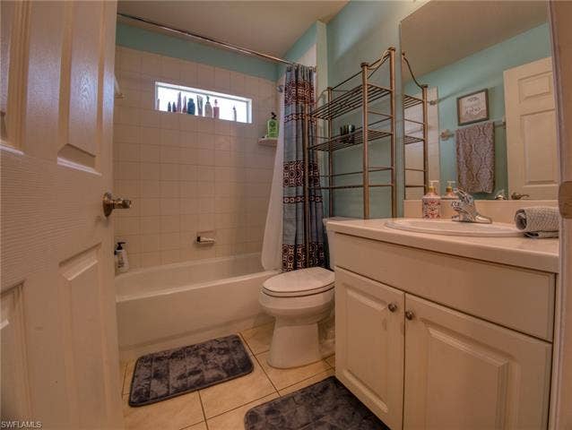 9071 Astonia Way, Estero, FL 33967 Bathroom with vanity, shower / tub combo, and light tile patterned floors