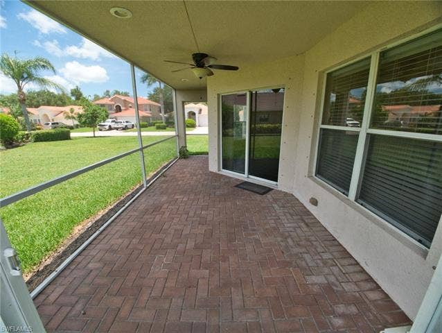 9071 Astonia Way, Estero, FL 33967 Screened patio featuring a ceiling fan, recessed lighting, and herringbone-patterned brick pavers