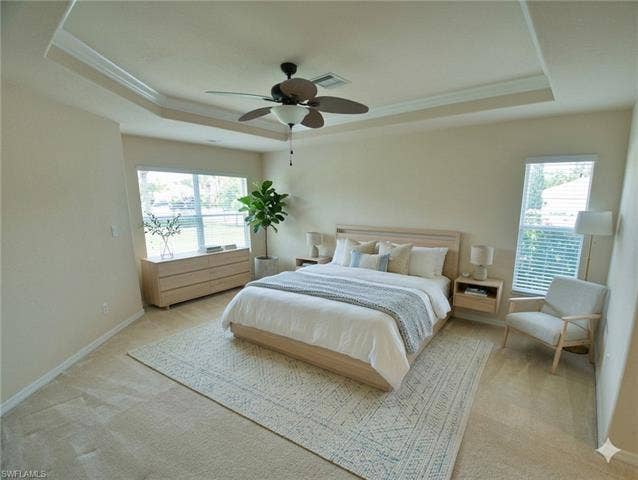 9071 Astonia Way, Estero, FL 33967 Spacious room featuring a tray ceiling with crown molding and a ceiling fan