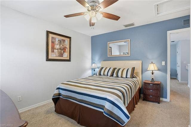 17801 Modena Rd, Miromar Lakes, FL 33913 Bedroom featuring light carpet and ceiling fan