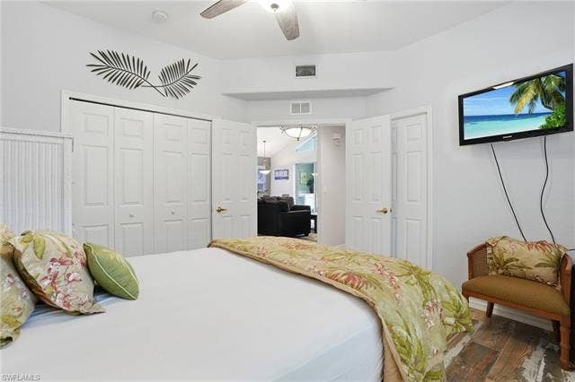 17801 Modena Rd, Miromar Lakes, FL 33913 Bedroom featuring wood finished floors, a closet, and a ceiling fan