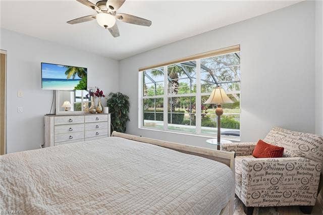 17801 Modena Rd, Miromar Lakes, FL 33913 Bedroom with a ceiling fan and wood finished floors