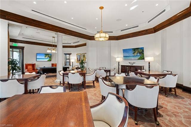 17801 Modena Rd, Miromar Lakes, FL 33913 Dining area with decorative columns and a tray ceiling
