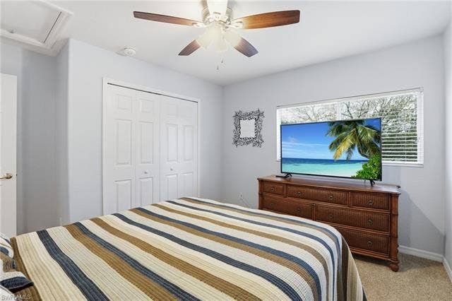 17801 Modena Rd, Miromar Lakes, FL 33913 Bedroom featuring light carpet, a closet, and a ceiling fan