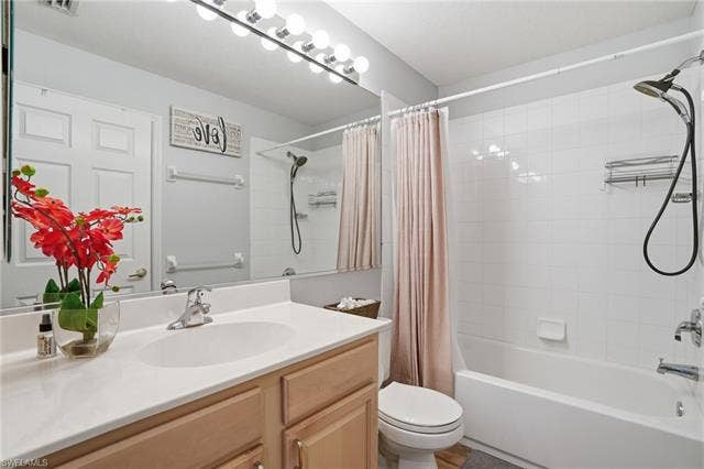 17801 Modena Rd, Miromar Lakes, FL 33913 Full bathroom with vanity and shower / tub combo