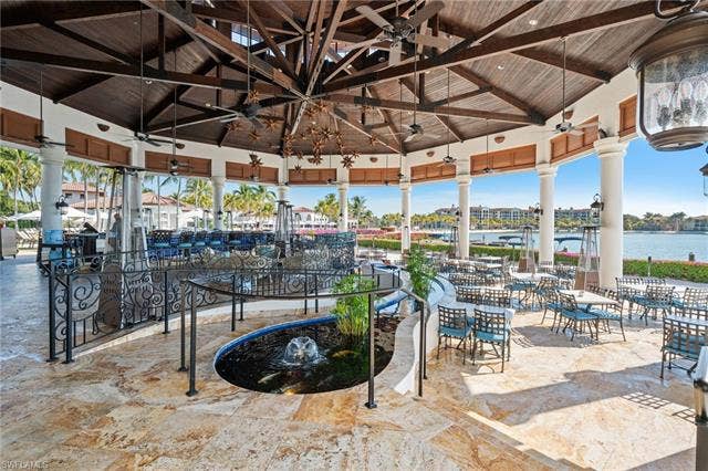 17801 Modena Rd, Miromar Lakes, FL 33913 View of patio featuring outdoor dining space and a water view