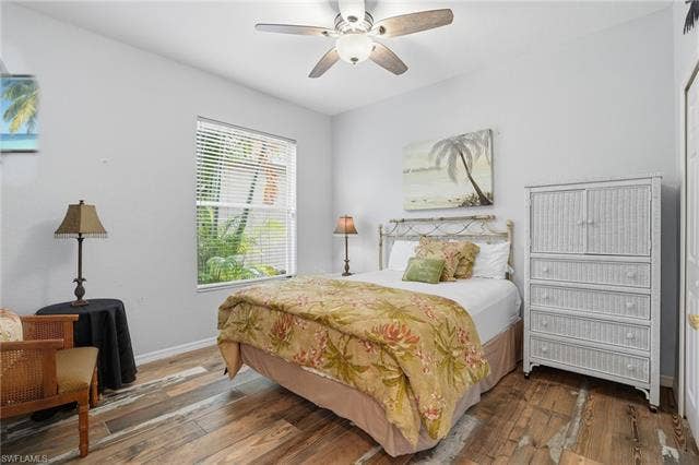 17801 Modena Rd, Miromar Lakes, FL 33913 Bedroom featuring wood-type flooring and a ceiling fan