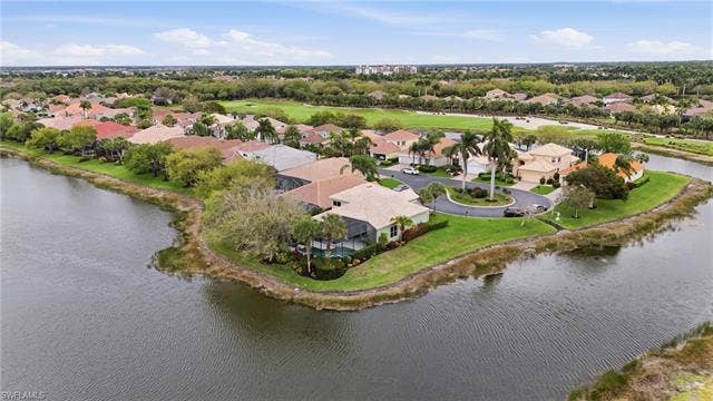 17801 Modena Rd, Miromar Lakes, FL 33913 Aerial perspective of suburban area featuring a large body of water