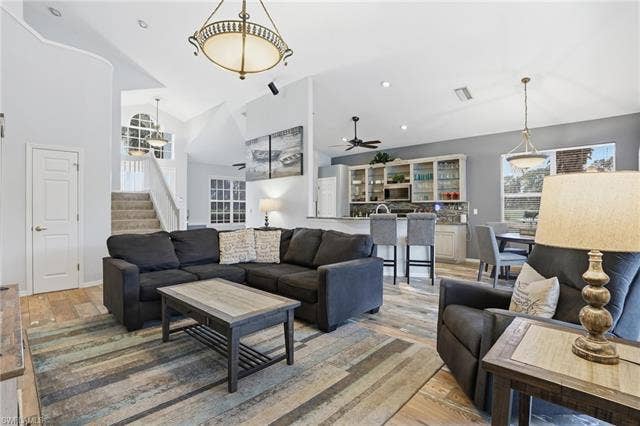 17801 Modena Rd, Miromar Lakes, FL 33913 Living area with light wood-style floors, vaulted ceiling, and recessed lighting