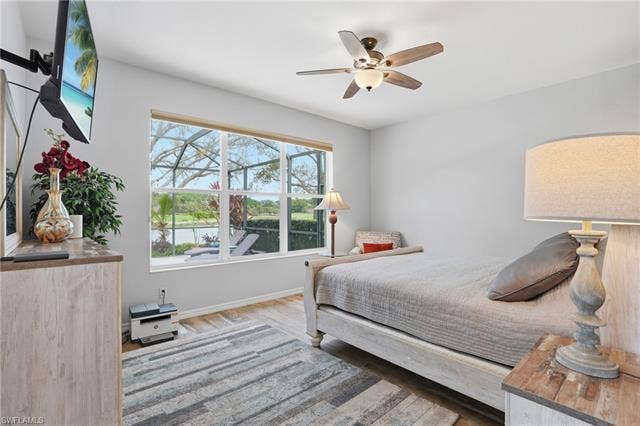 17801 Modena Rd, Miromar Lakes, FL 33913 Bedroom with ceiling fan and light wood-style floors
