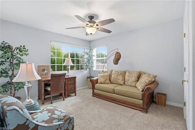 17801 Modena Rd, Miromar Lakes, FL 33913 Living area featuring light colored carpet and a ceiling fan
