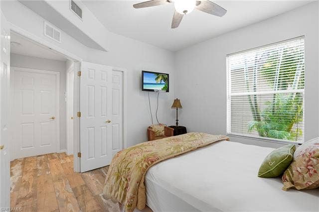 17801 Modena Rd, Miromar Lakes, FL 33913 Bedroom with light wood-style floors and a ceiling fan