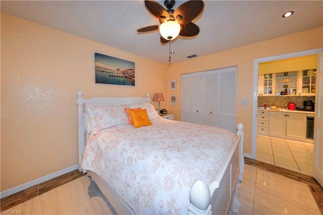 22161 Tallwood Ct, #706, Estero, FL 33928 Living space with a ceiling fan, recessed lighting, and a closet with louvered bifold doors