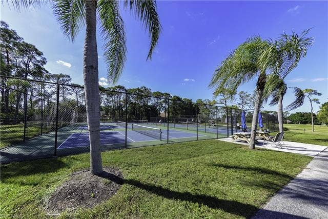 22161 Tallwood Ct, #706, Estero, FL 33928 Fenced tennis courts with blue and green surfaces