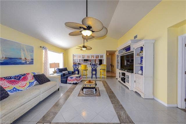 22161 Tallwood Ct, #706, Estero, FL 33928 Living area featuring vaulted ceilings, patterned tile flooring, and multiple ceiling fans