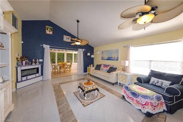 22161 Tallwood Ct, #706, Estero, FL 33928 Vaulted ceilings accent a spacious living area featuring tiled flooring with a decorative inlay
