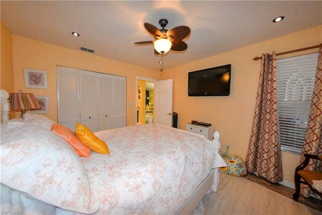 22161 Tallwood Ct, #706, Estero, FL 33928 Recessed lighting, wood-finish flooring, and louvered bifold closet doors