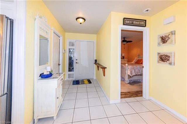 22161 Tallwood Ct, #706, Estero, FL 33928 White tile flooring throughout the hallway