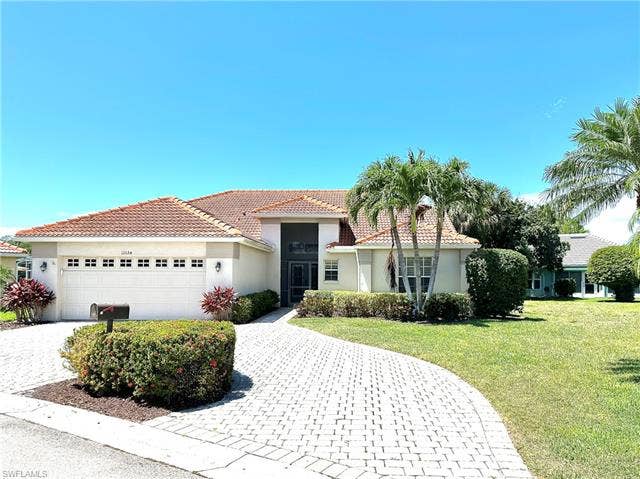 12654 Buttonbush Pl, Bonita Springs, FL 34135 The circular, paver driveway adds curb appeal and convenience for the owner.
