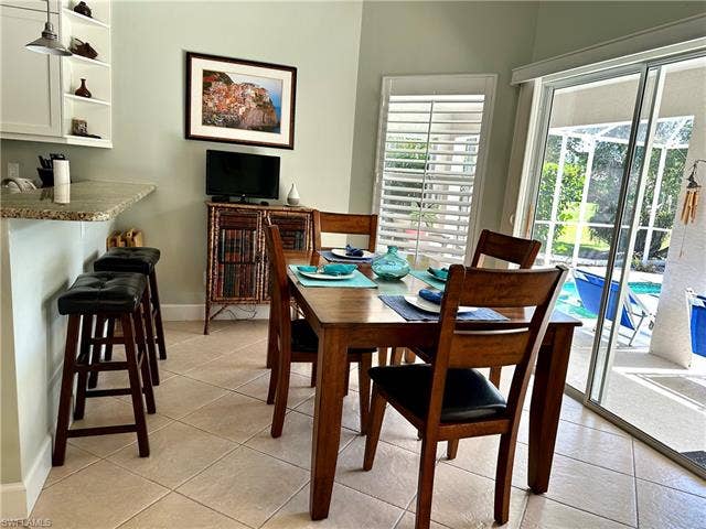 12654 Buttonbush Pl, Bonita Springs, FL 34135 The kitchen includes a breakfast bar and a full size table for dining.