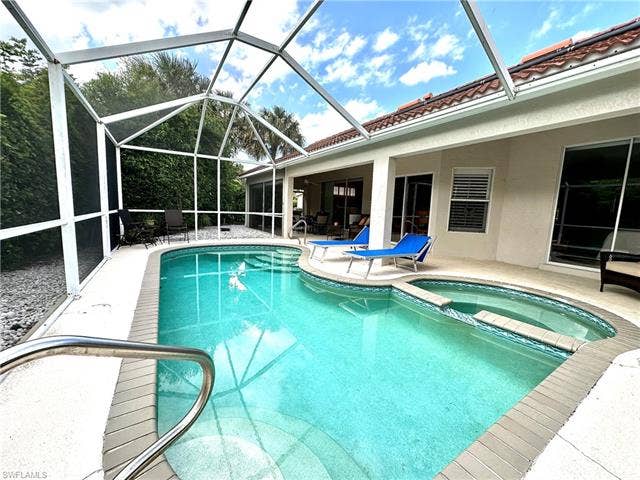 12654 Buttonbush Pl, Bonita Springs, FL 34135 Home is designed for outdoor living with a pool and patio area that extends the full length of the house.