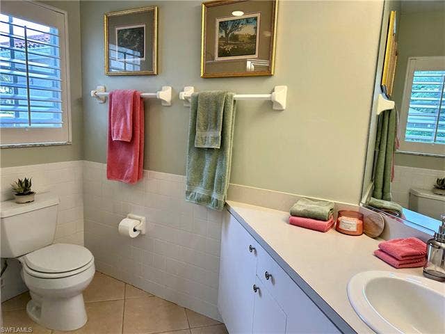 12654 Buttonbush Pl, Bonita Springs, FL 34135 The 2nd bathroom is adjacent to bedroom 2 and 3. It has a shower and a single sink.