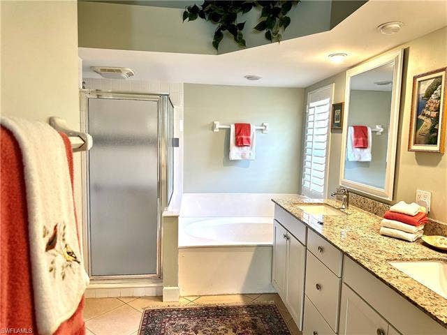 12654 Buttonbush Pl, Bonita Springs, FL 34135 The main en suite bath features a bath tub, a step in shower, and a water closet, for privacy.