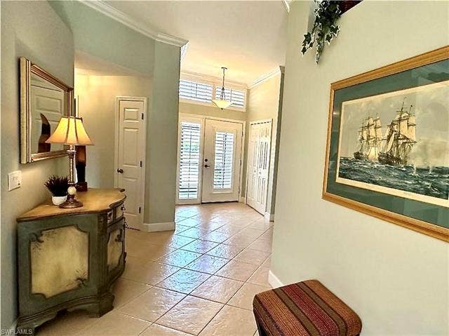 12654 Buttonbush Pl, Bonita Springs, FL 34135 The front entry is open and airy. The entry door and the windows throughout the house have plantation shutters. A nice feature for southern homes, and also an added value.