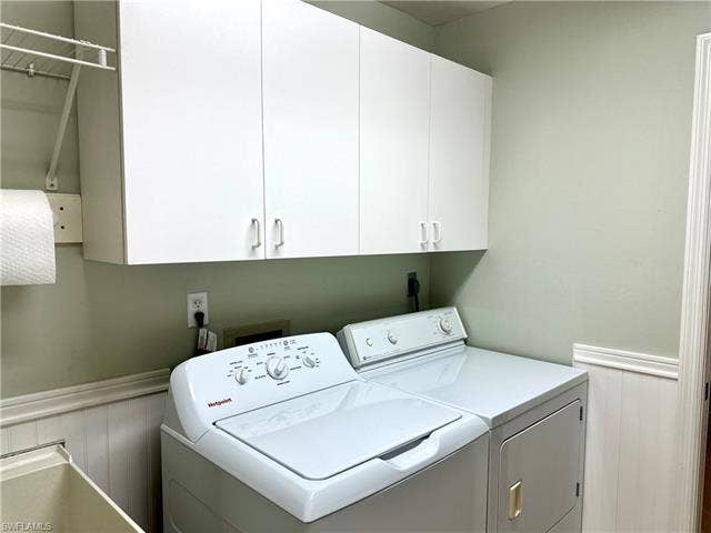 12654 Buttonbush Pl, Bonita Springs, FL 34135 The laundry room includes storage cabinets and a laundry sink.
