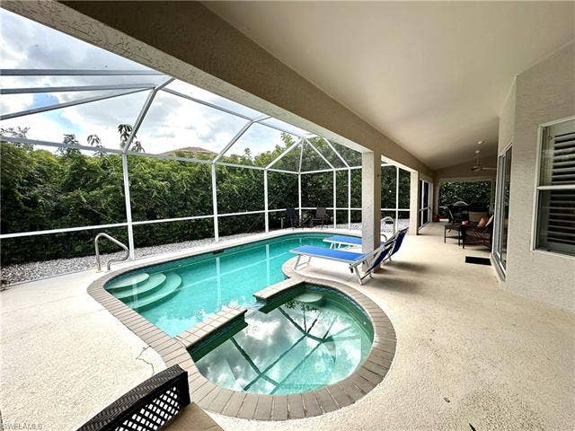 12654 Buttonbush Pl, Bonita Springs, FL 34135 The pool features a built in hot tub/spa.