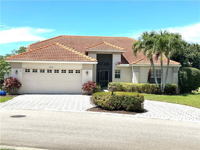 12654 Buttonbush Pl, Bonita Springs, FL 34135 This house is designed for outdoor living with a pool and patio area that extends the full length of the house.