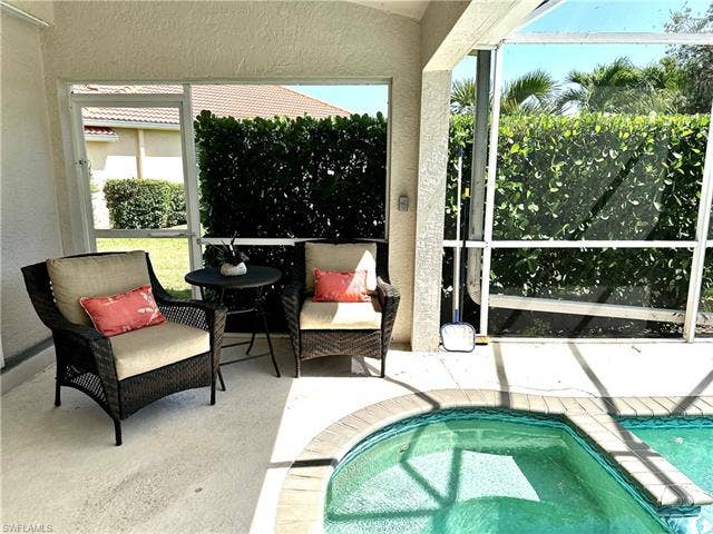12654 Buttonbush Pl, Bonita Springs, FL 34135 There is a shaded sitting area just outside the main bedroom sliding doors.