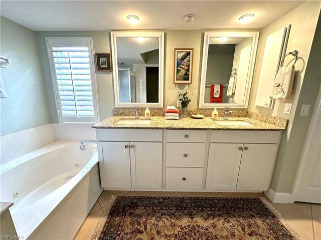 12654 Buttonbush Pl, Bonita Springs, FL 34135 The vanity is updated, and features granite, double sinks and plenety of storage.