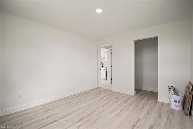 2316 Bayside St, Naples, FL 34112 Unfurnished bedroom with light wood finished floors and recessed lighting